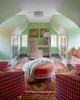 Armchairs upholstered in Crémaillère Hot Pink in room pale green walls and colourful rug. Design by Philip Thomas, Photography By Michael Mundy